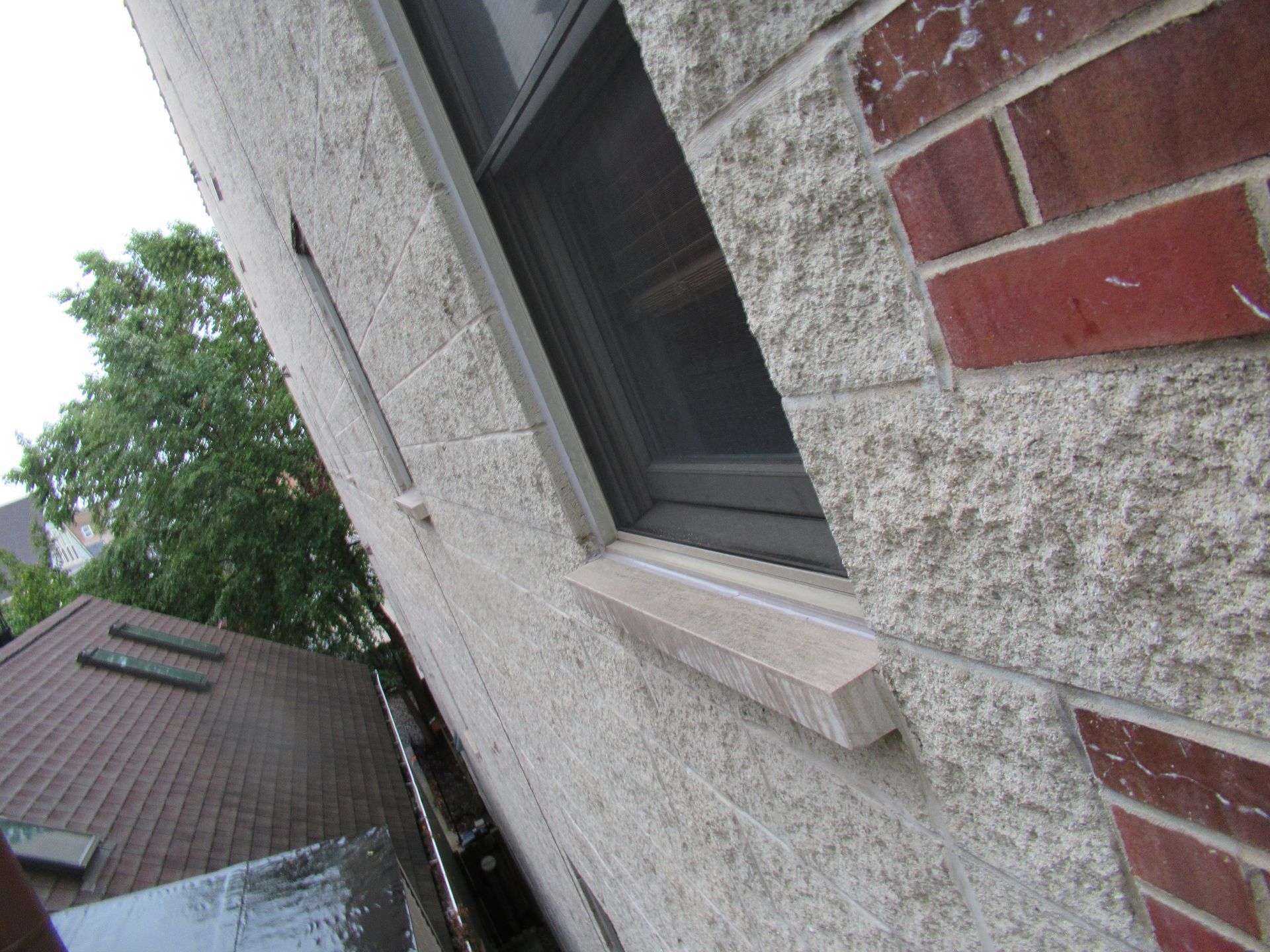 Unflashing limestone window sill causing leaking, Uptown, Chicago
