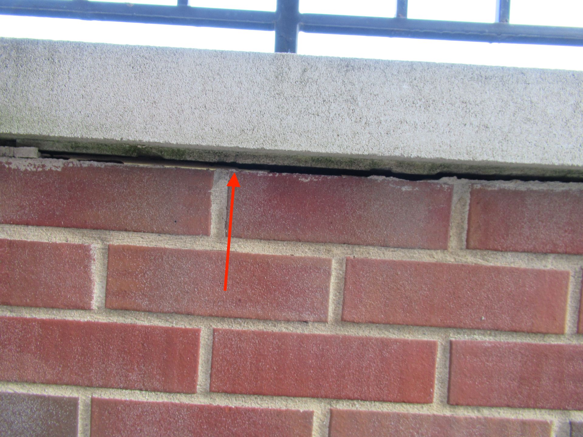 Balcony parapet with missing mortar, no flashing, no drip edge in Uptown, Chicago