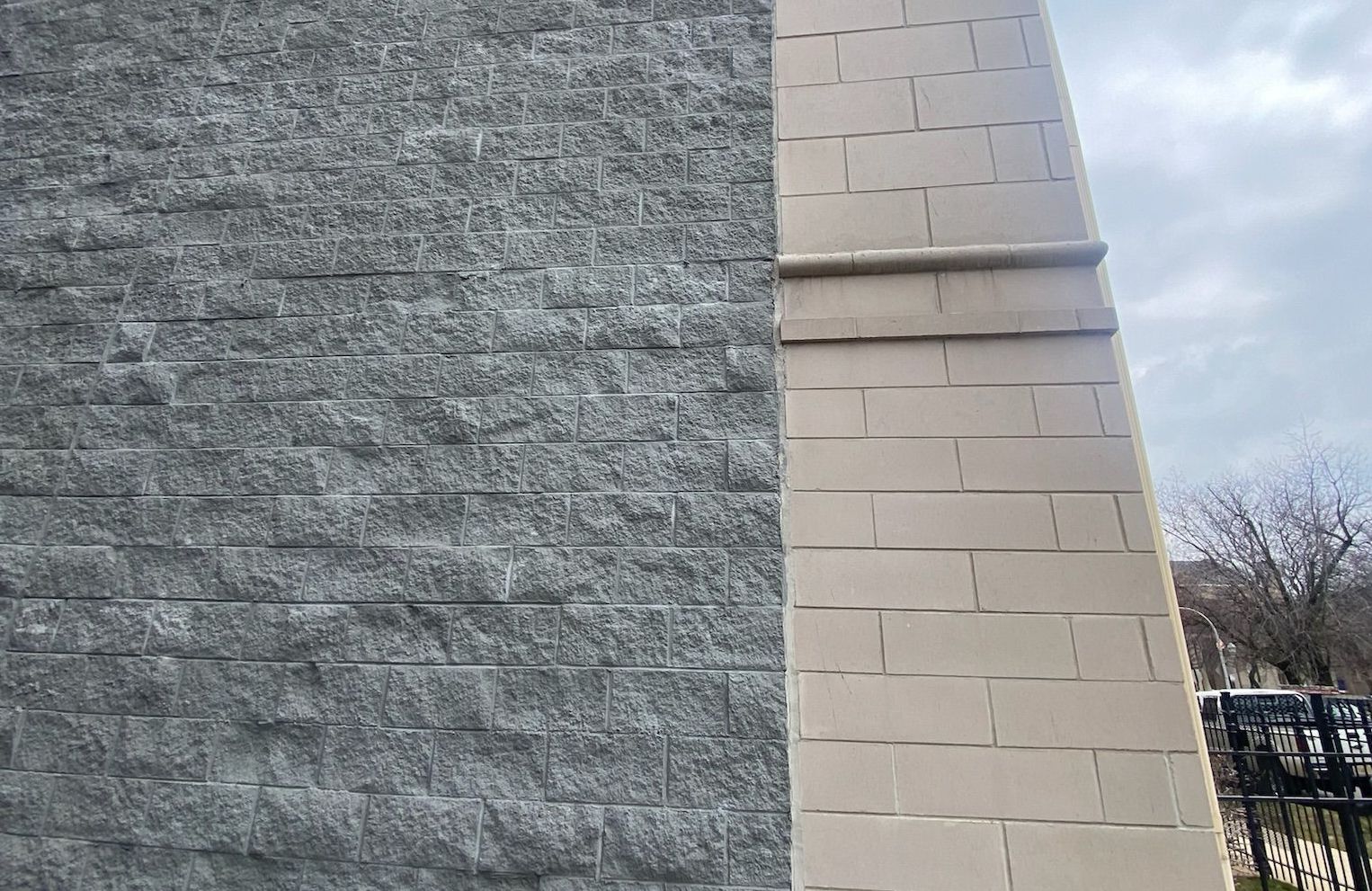 Transition between split face block and Renaissance sections of a building's wall in Bronzeville, Chicago