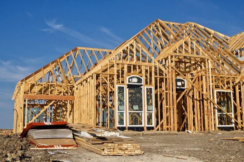 A house that is being built with a blue sky in the background