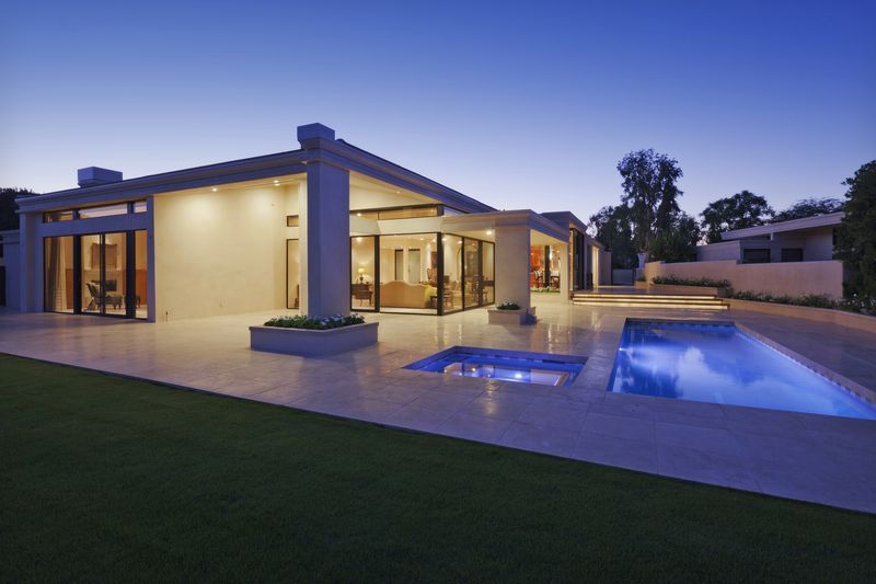 A modern house with a large swimming pool in the backyard