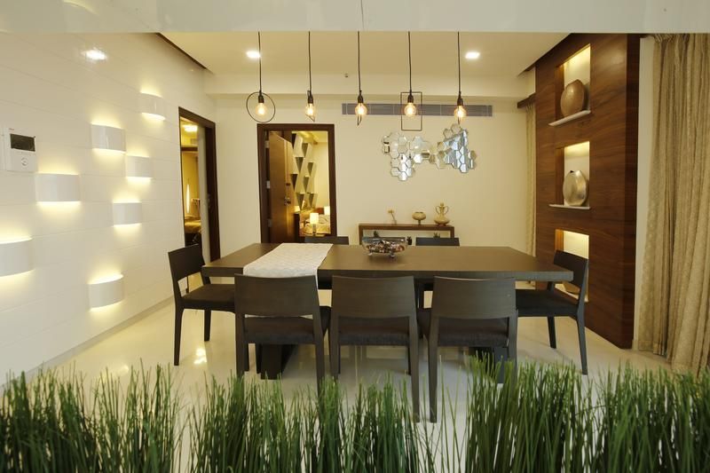 A dining room with a long table and chairs