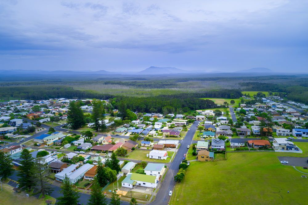 An Aerial View Of A Residential Area With A Mountain — Newcastle Moving & Storage in Warnervale, NSW