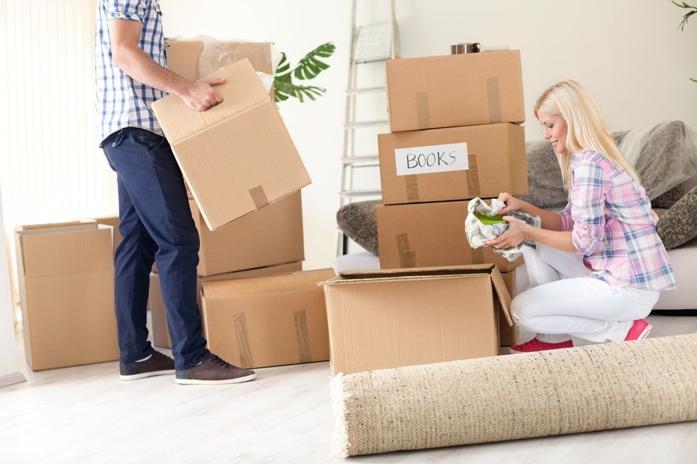A Man And A Woman Are Moving Into A New Home — Newcastle Moving & Storage in Warnervale, NSW
