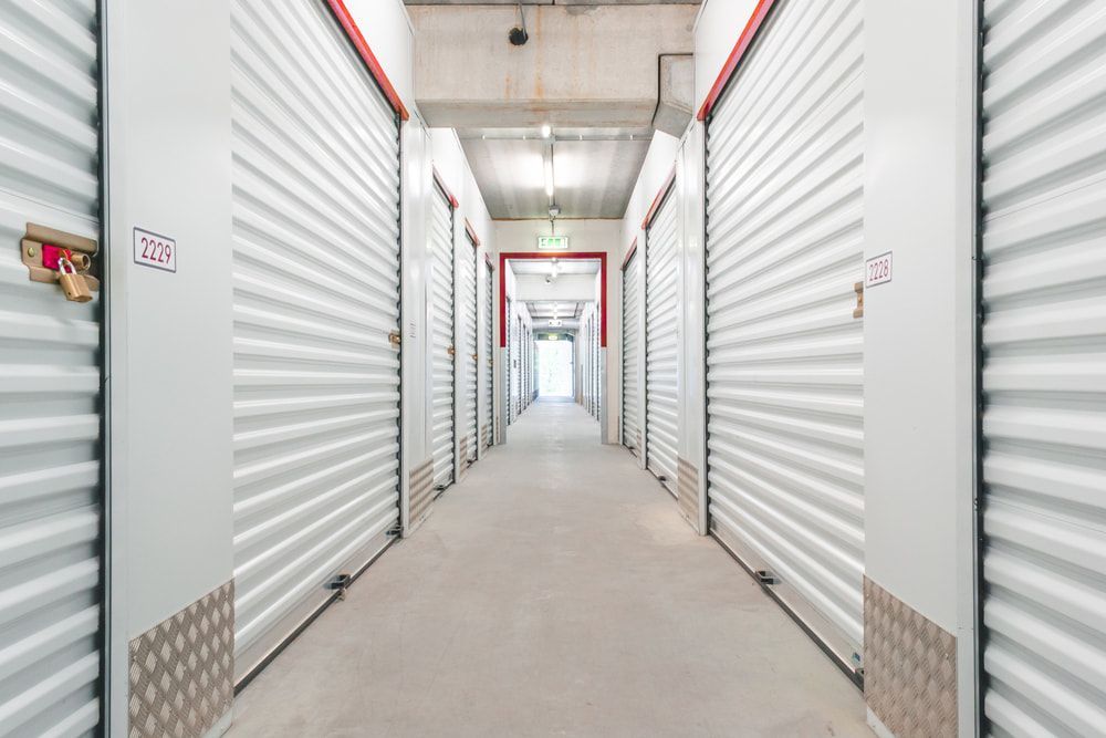 A Long Hallway Filled With Lots Of Empty Storage Units — Newcastle Moving & Storage in Salt Ash, NSW