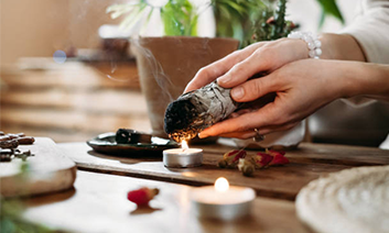 Person receiving sound healing with bowls, a kalimba, and a patterned cloth.