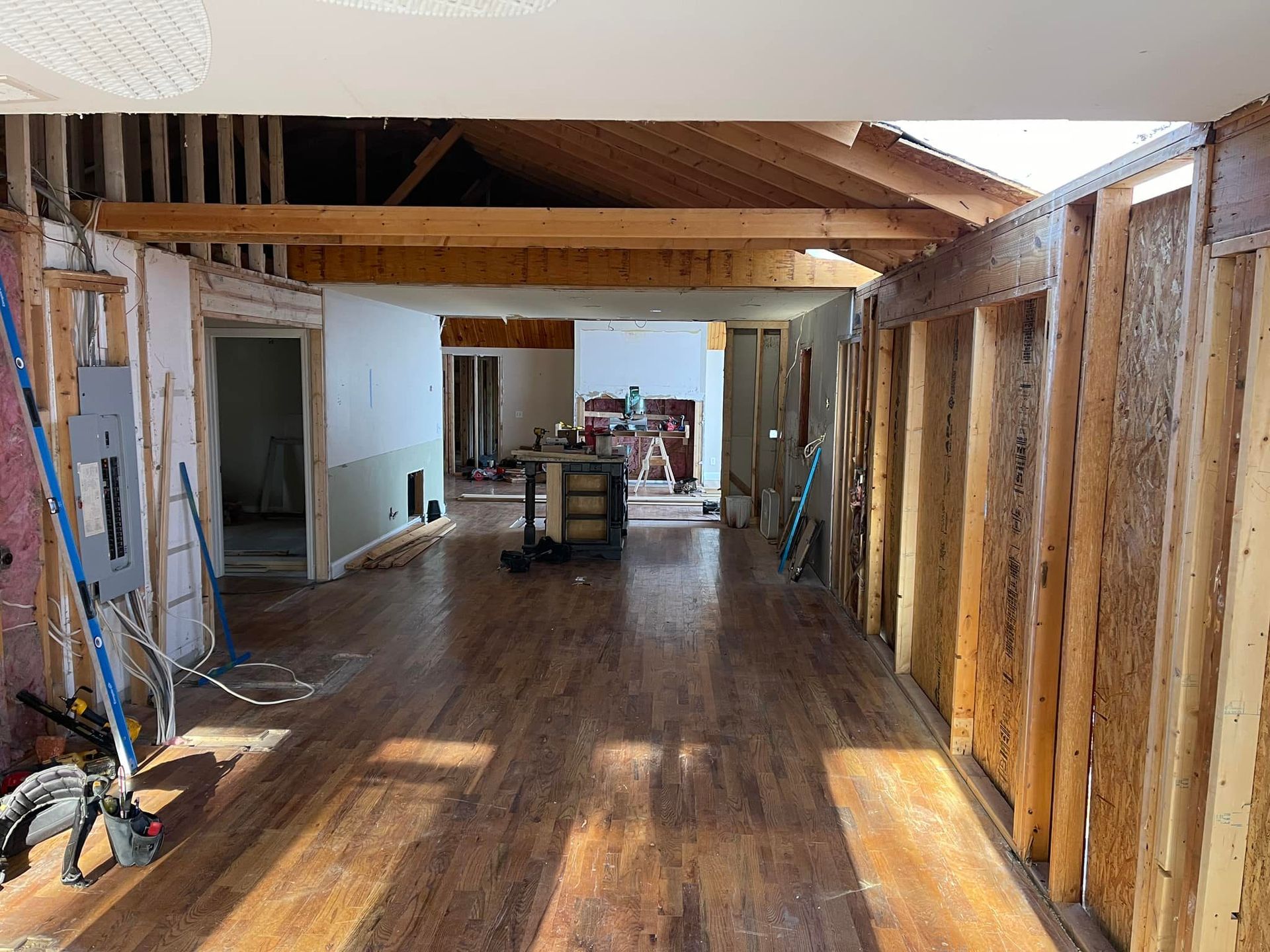 A large room with hardwood floors is being remodeled.