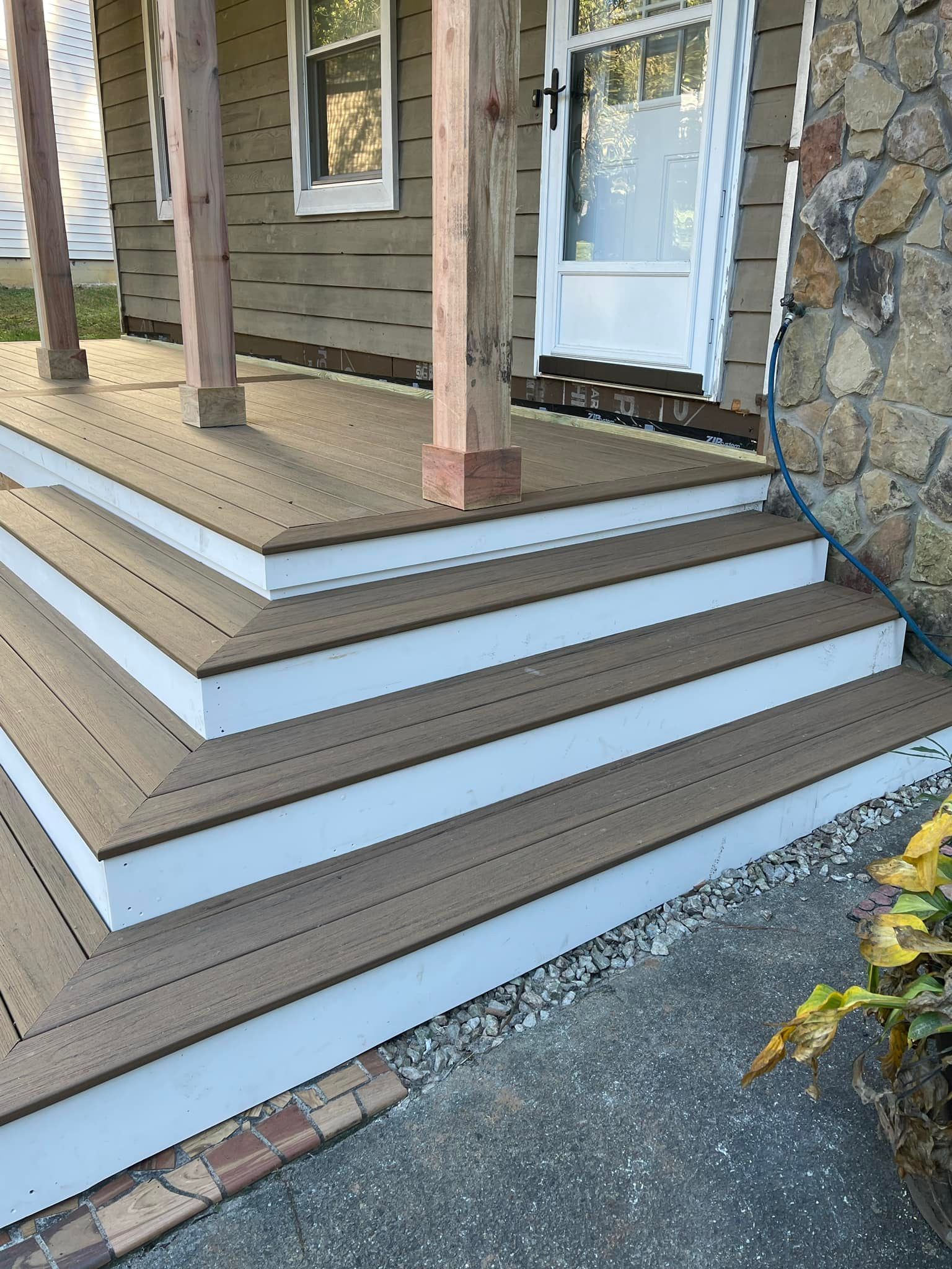 A house with a porch and stairs leading up to it.