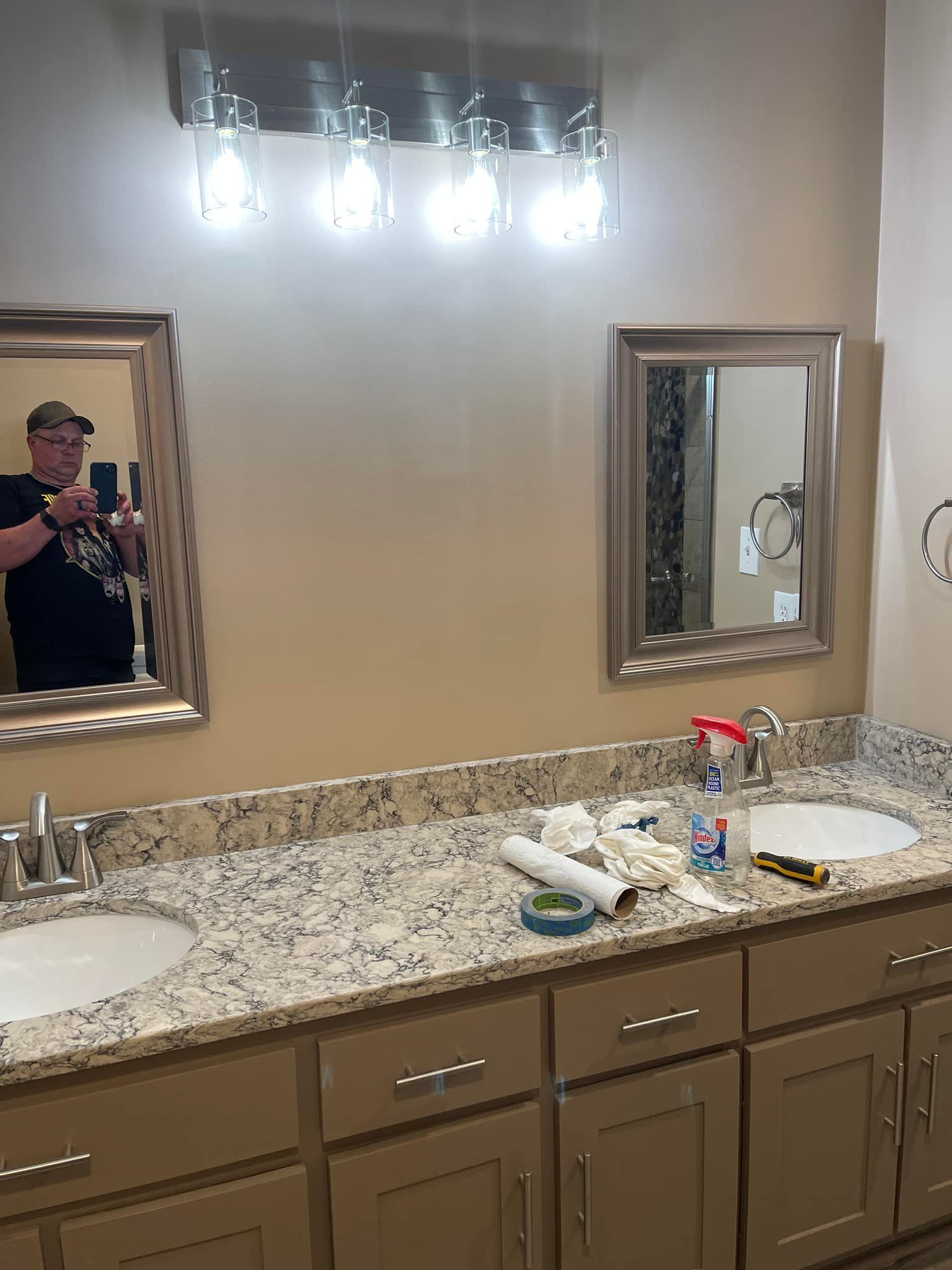 A man is taking a picture of himself in a bathroom mirror.