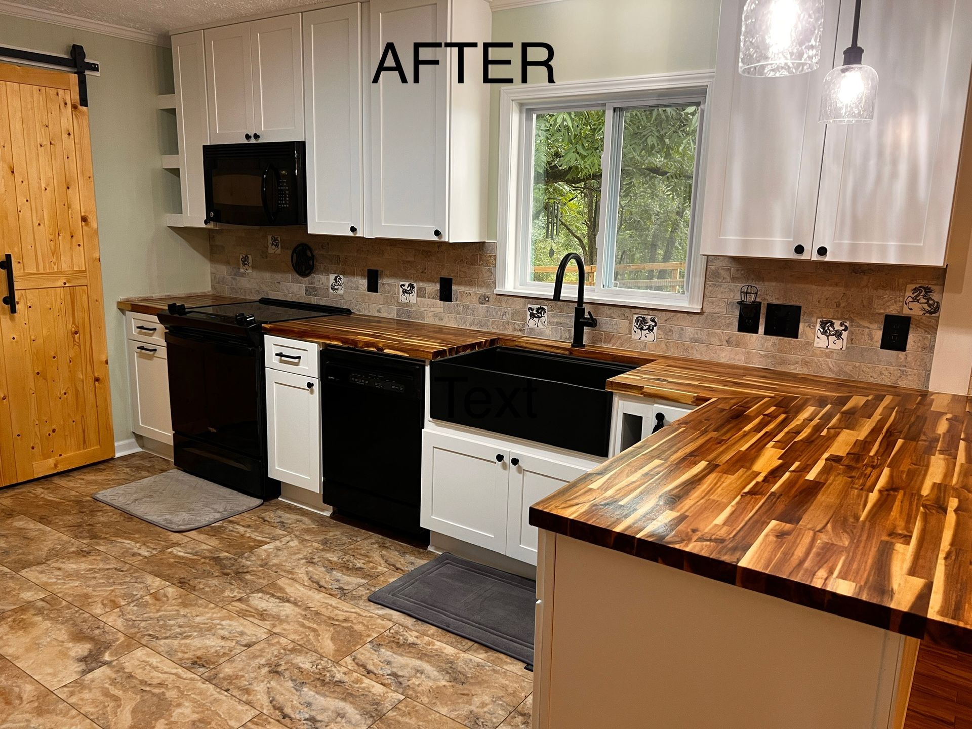 Renovated kitchen with white cabinets, wood countertops, black appliances, and a barn door.