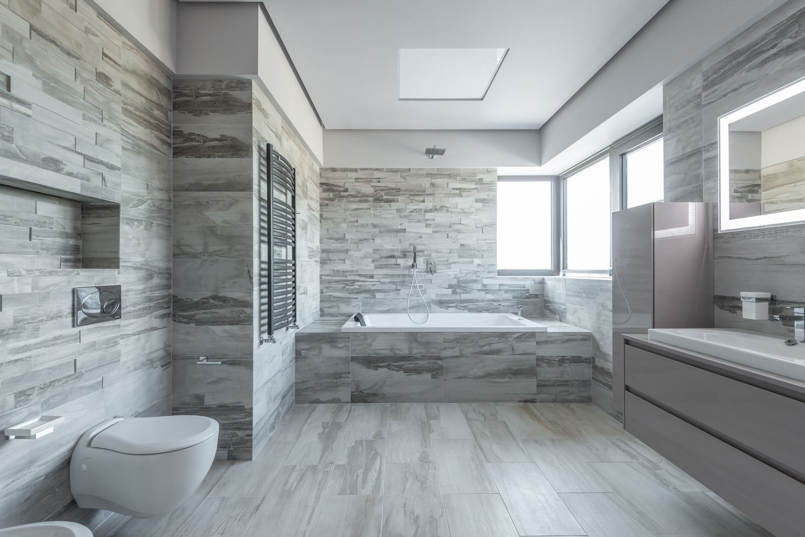 A bathroom with a toilet , sink , and bathtub.