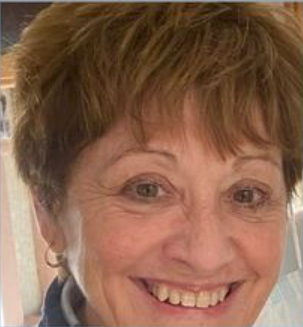 A close up of a woman 's face smiling.