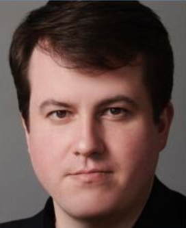 A close up of a man 's face with a serious look on his face.