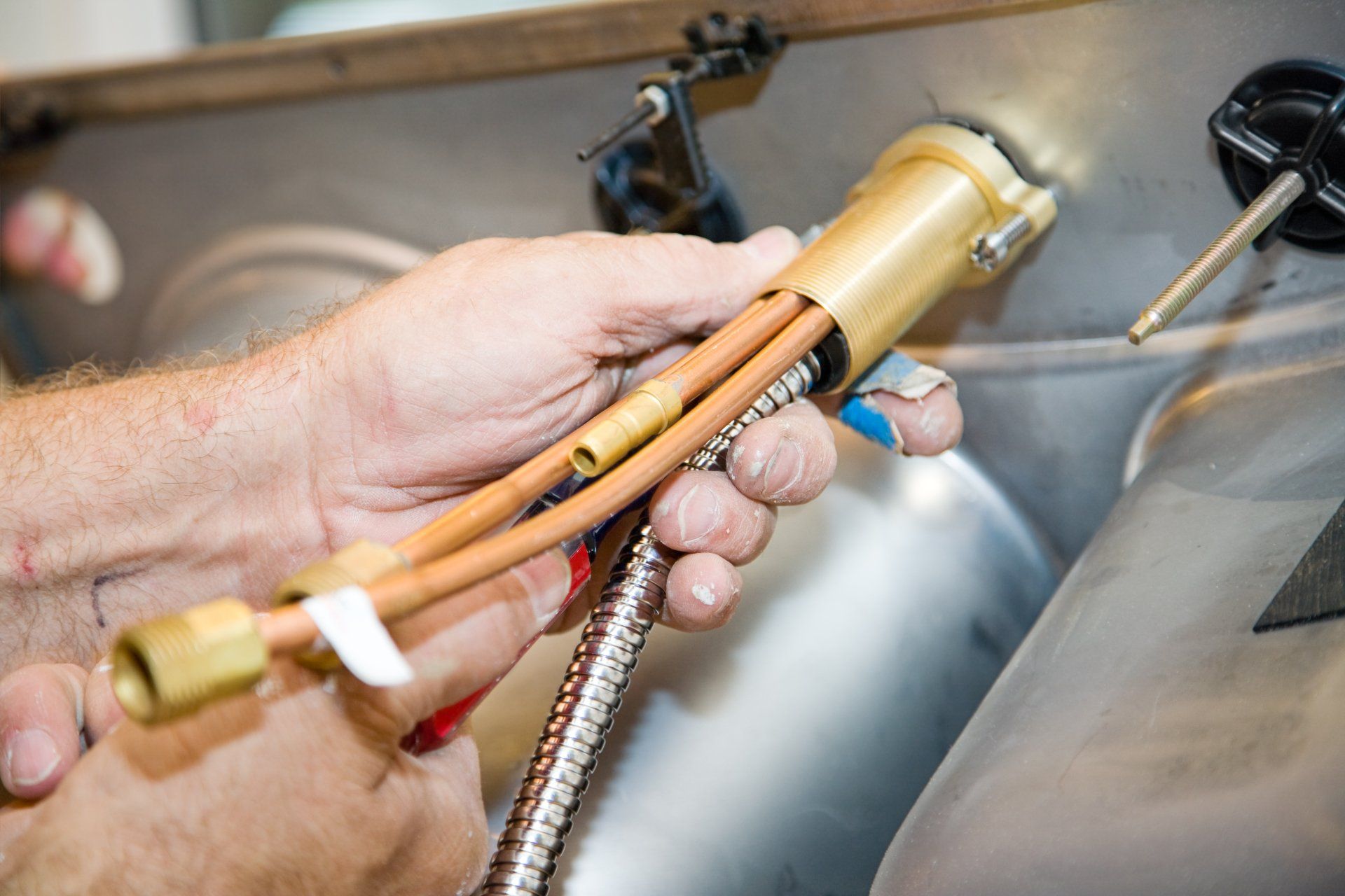 Closeup Installing a Faucet — Wet & Dry Plumbing & Gas in Newtown, QLD