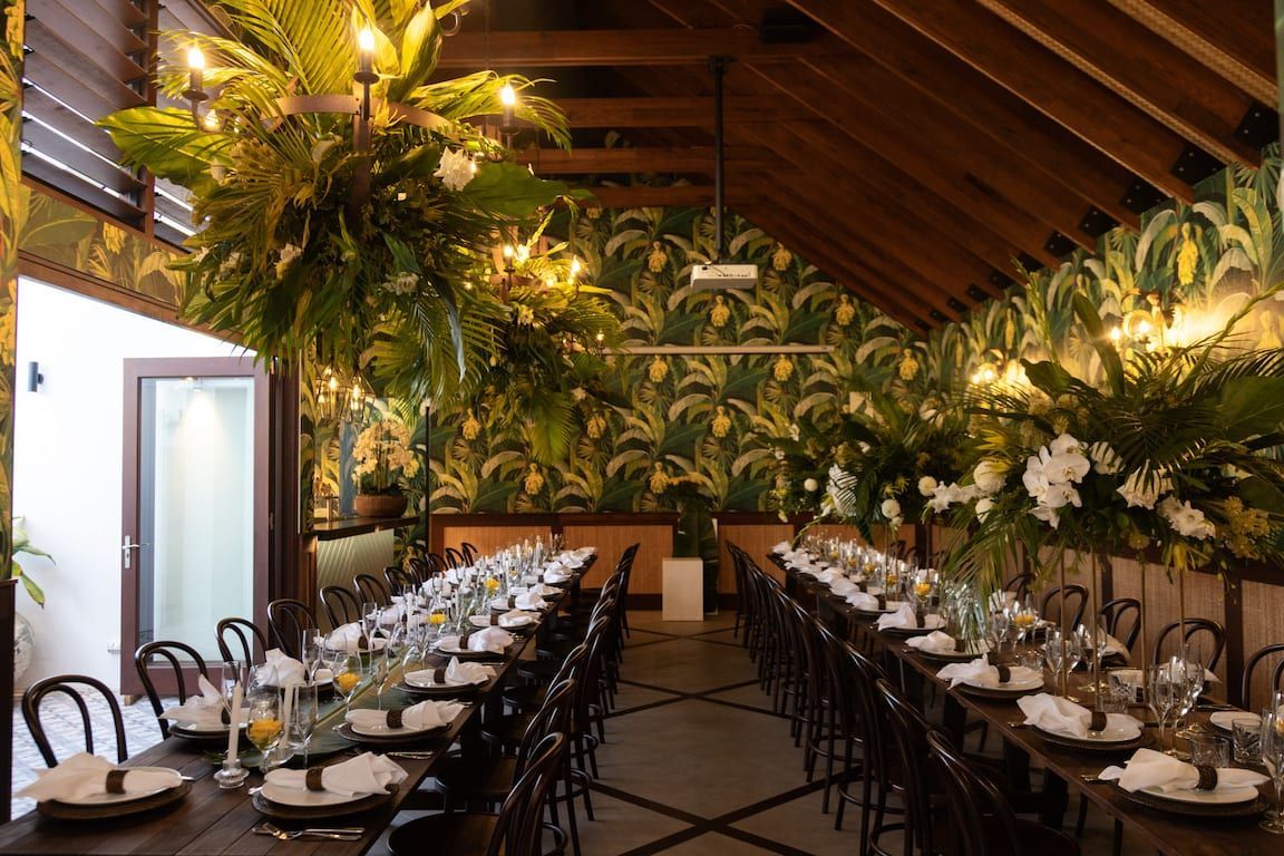 There are a lot of tables and chairs in the room.