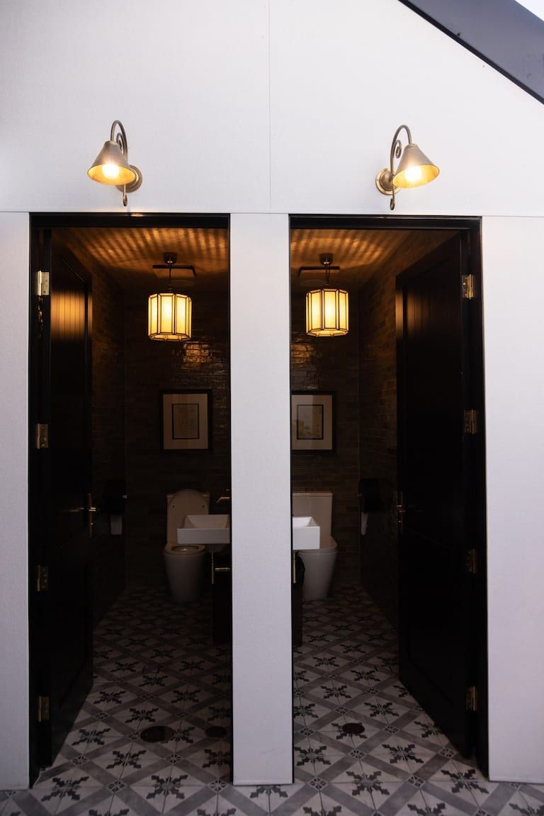 Two toilets are next to each other in a bathroom
