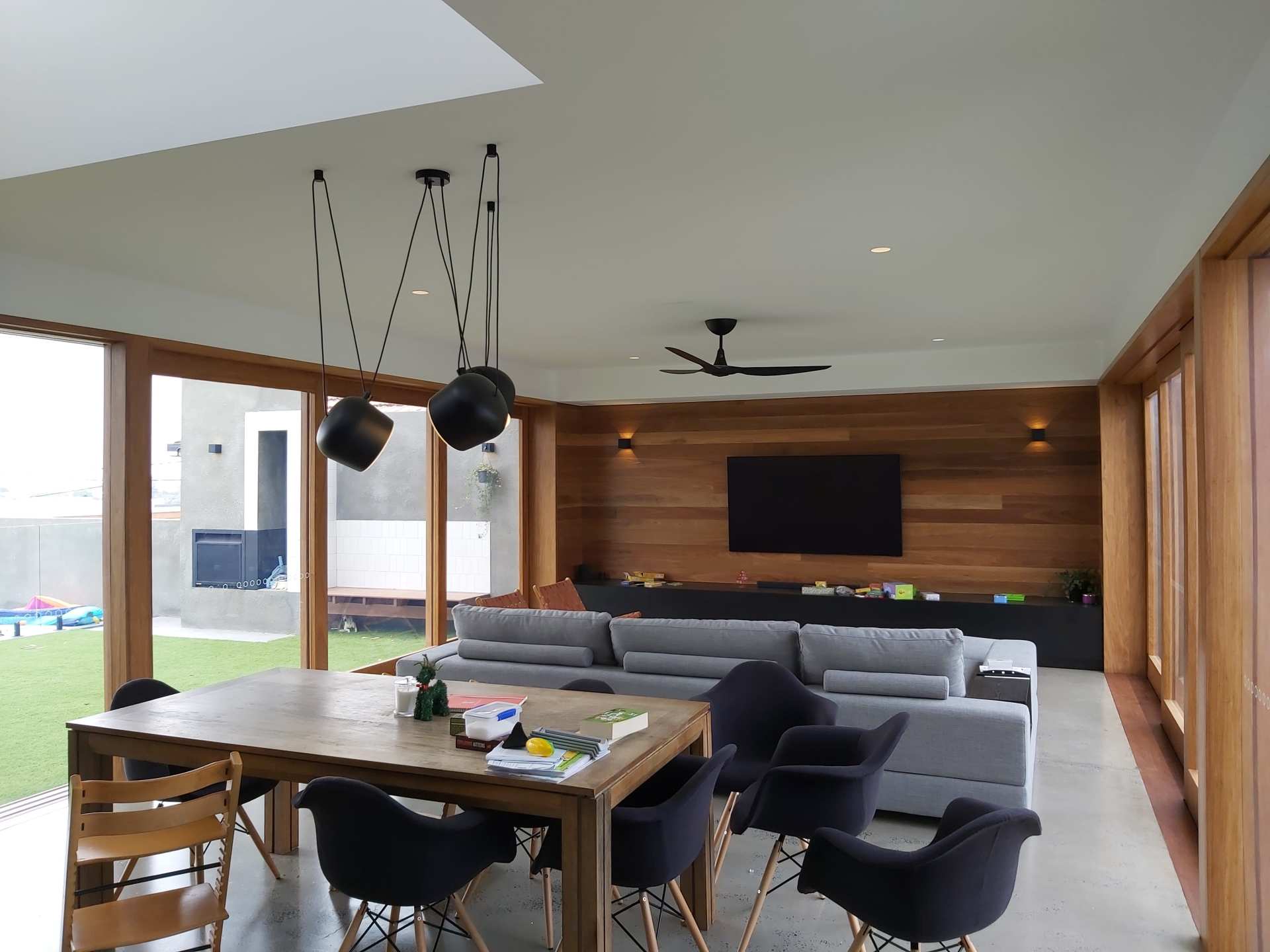 A living room with a table and chairs and a television