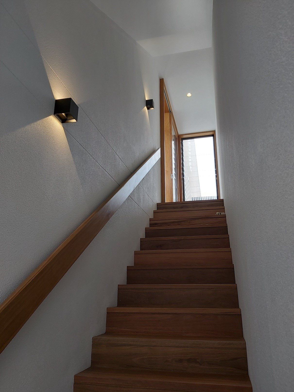 A wooden staircase leading up to the second floor of a house