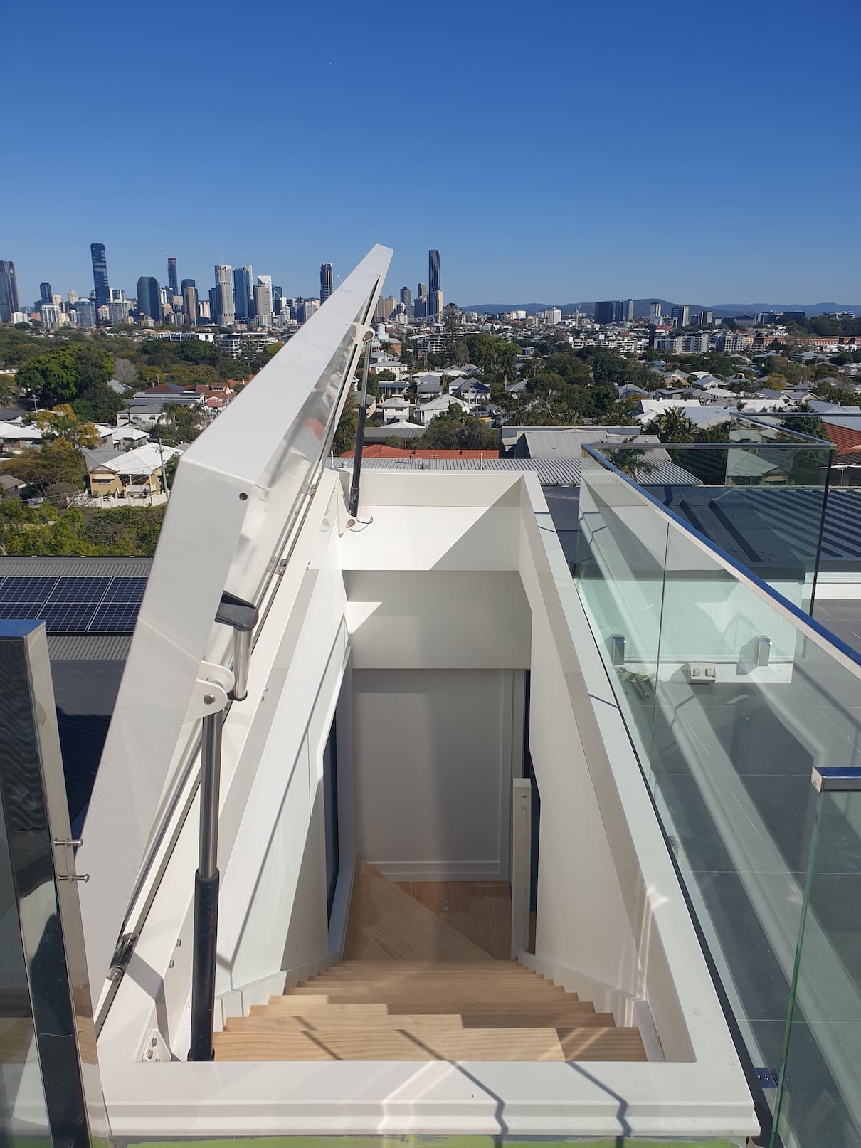A view of a city from the top of a building.
