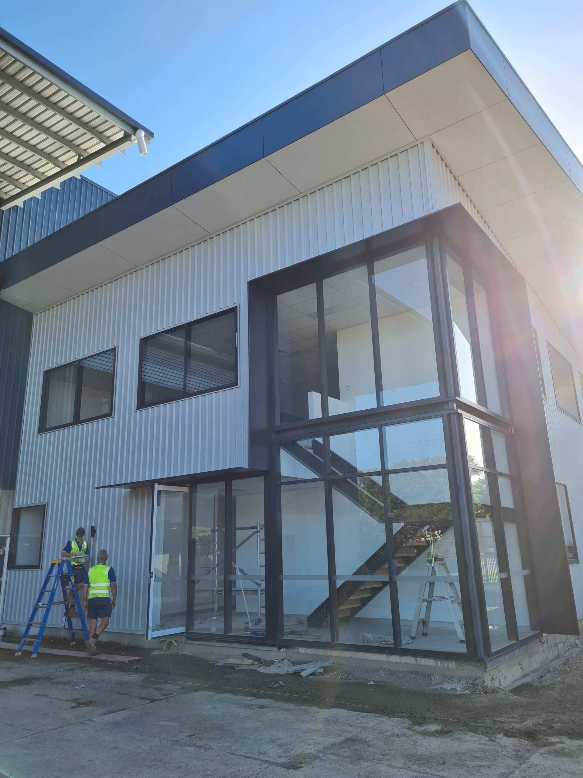 A large building with a lot of windows and stairs is being built.