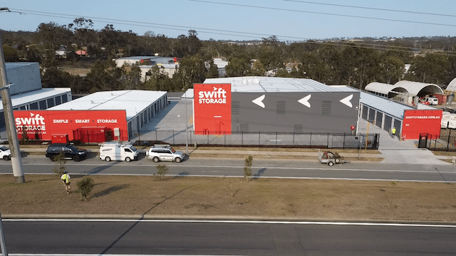 An aerial view of a storage facility next to a road.