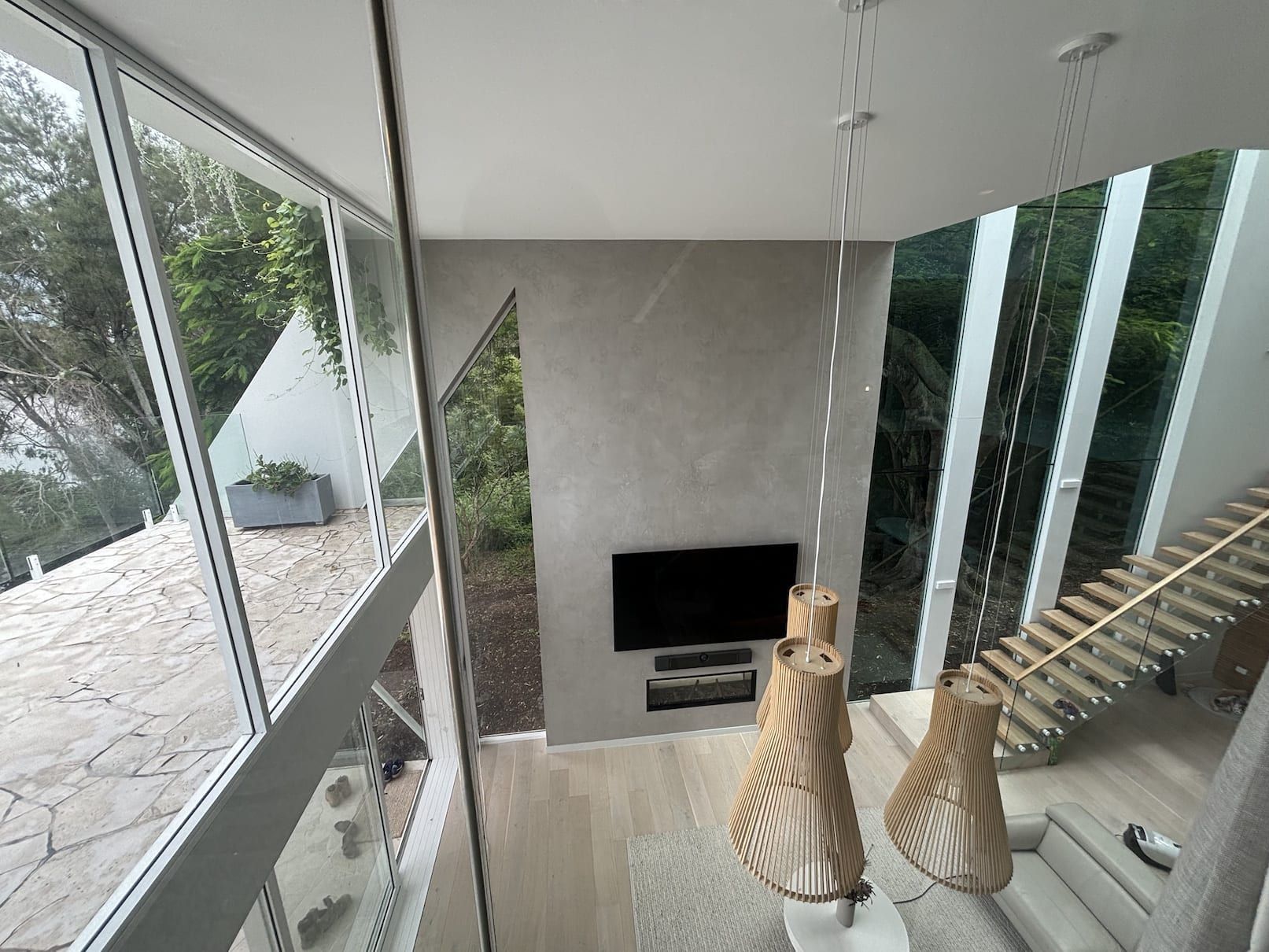 A living room with a flat screen tv and stairs