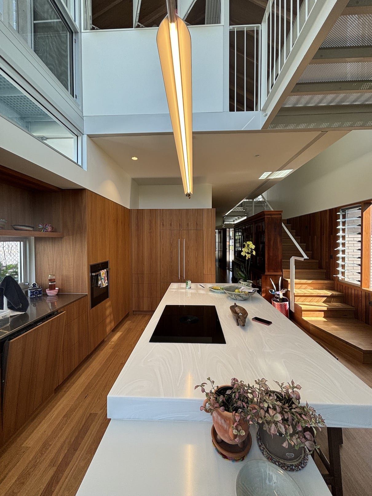 A kitchen with a large island and a stove top oven.