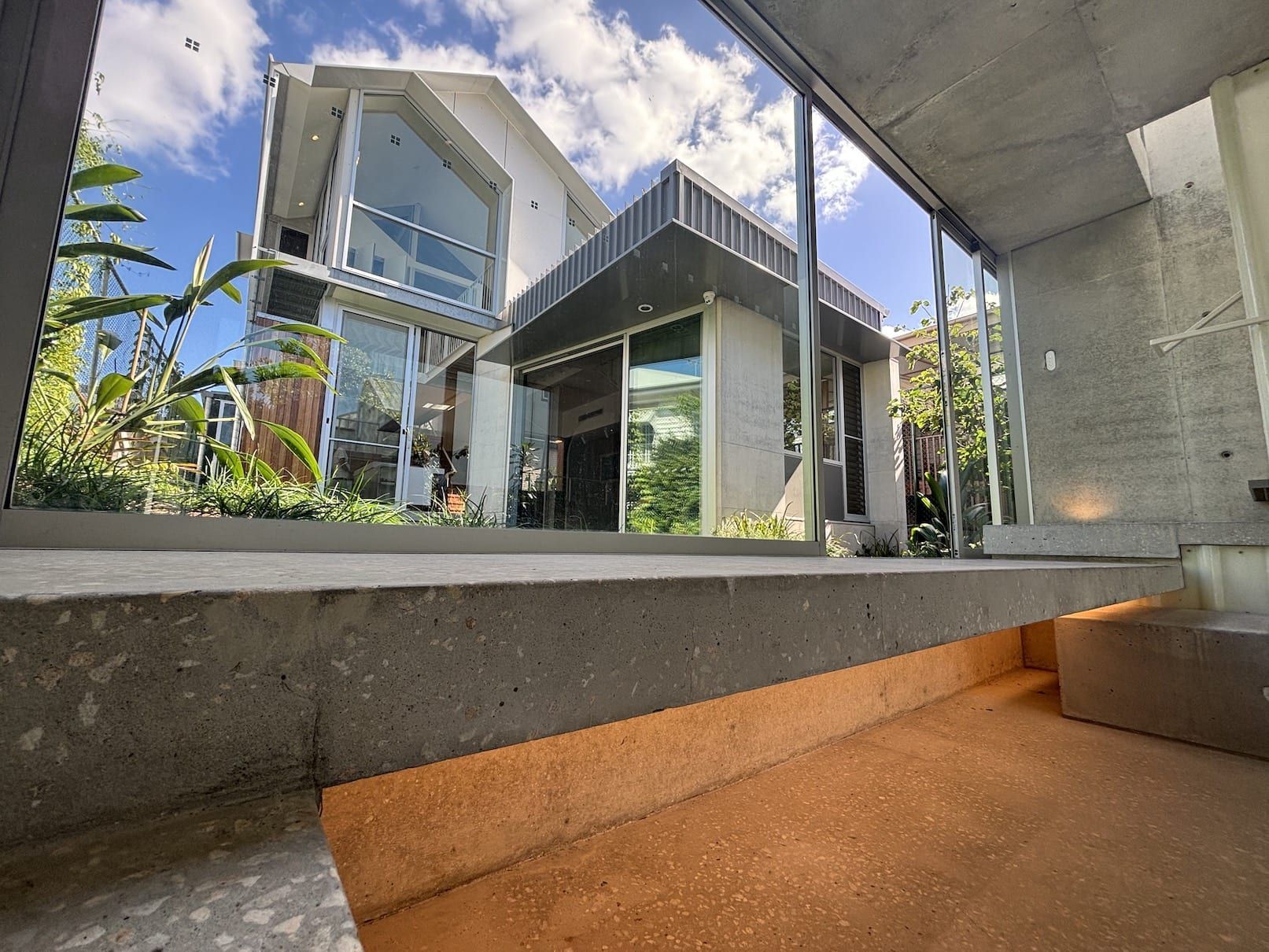 A large house with a lot of windows and stairs in front of it.