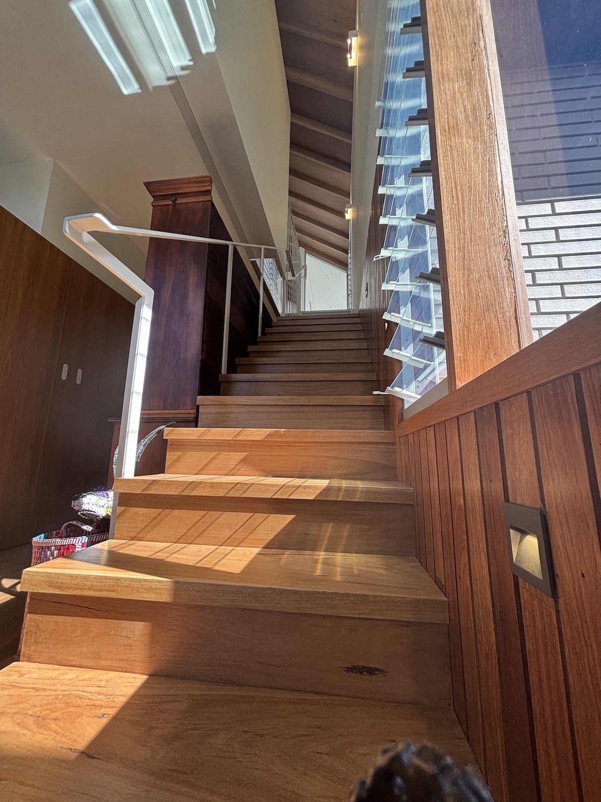 A person is walking up a set of wooden stairs.