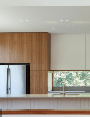 A kitchen with stainless steel appliances and wooden cabinets