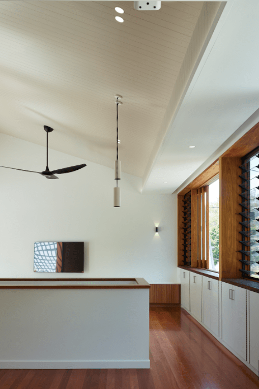 A ceiling fan hangs from the ceiling of a room