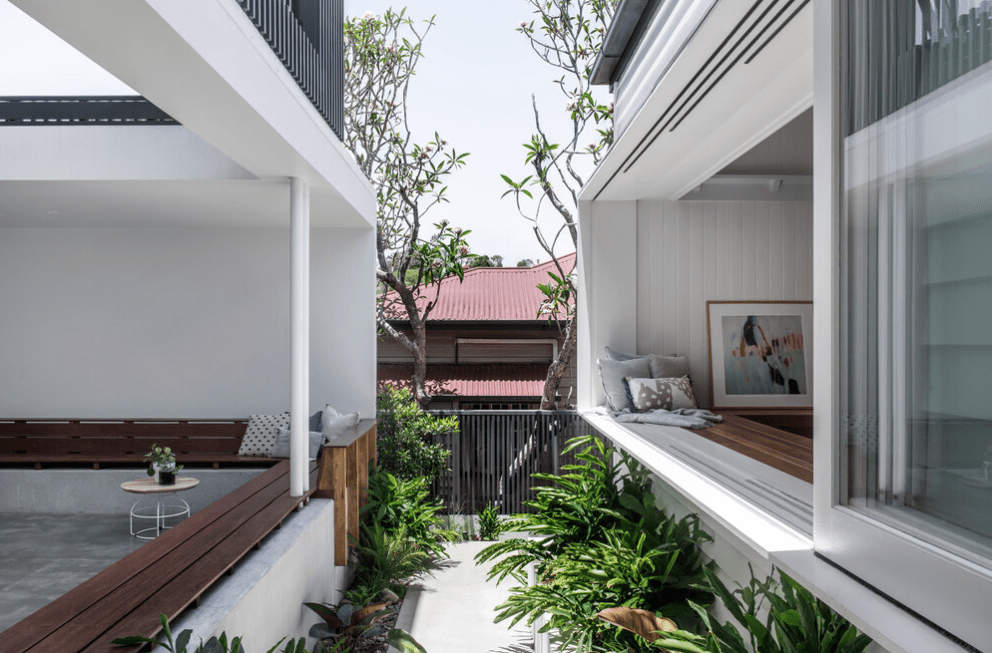 A house with a lot of windows and a wooden deck.
