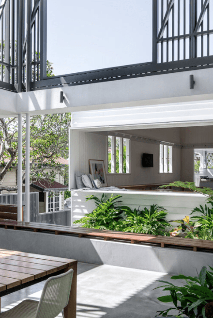 There is a table and chairs in the middle of the room.