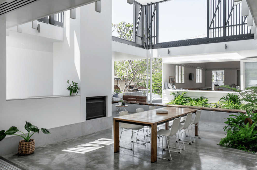 There is a table and chairs in the middle of the room.