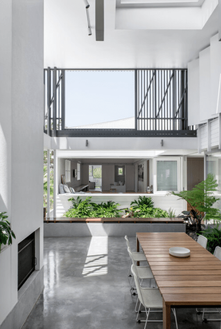 There is a table and chairs in the middle of the room.