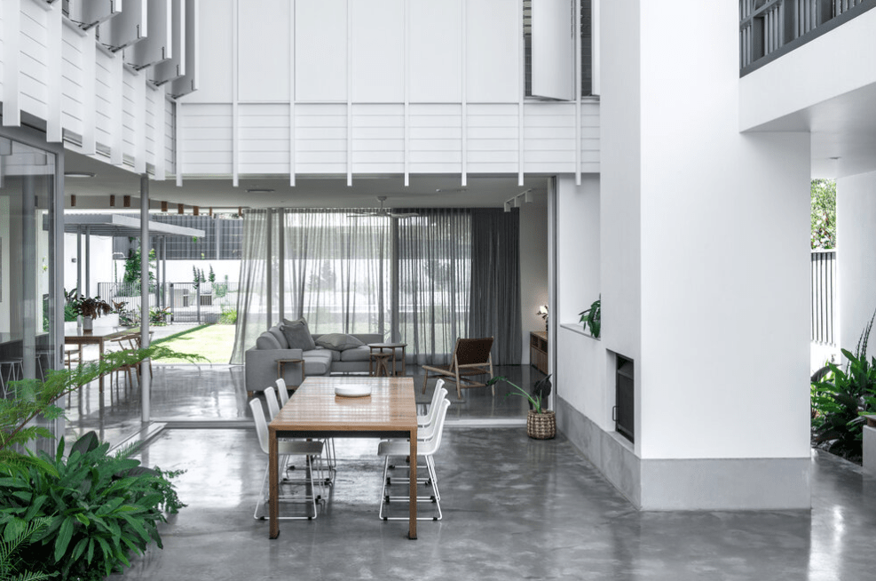 There is a table and chairs in the middle of the room.