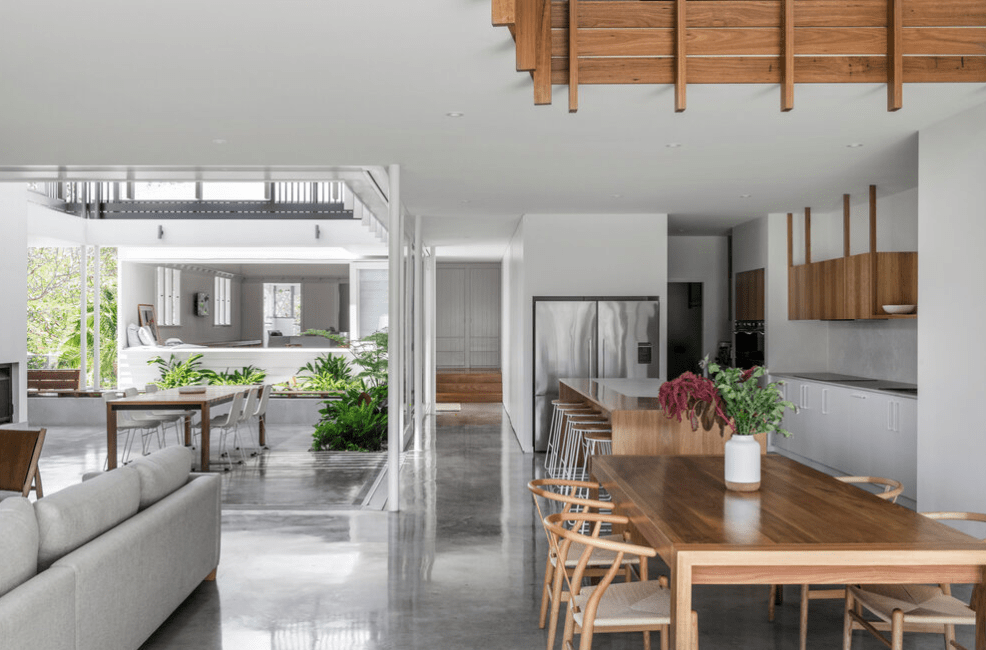 There is a table and chairs in the middle of the room.