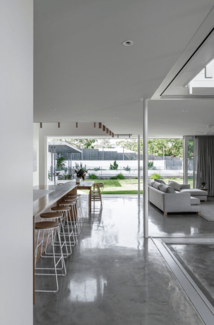 A living room with a white couch and stools