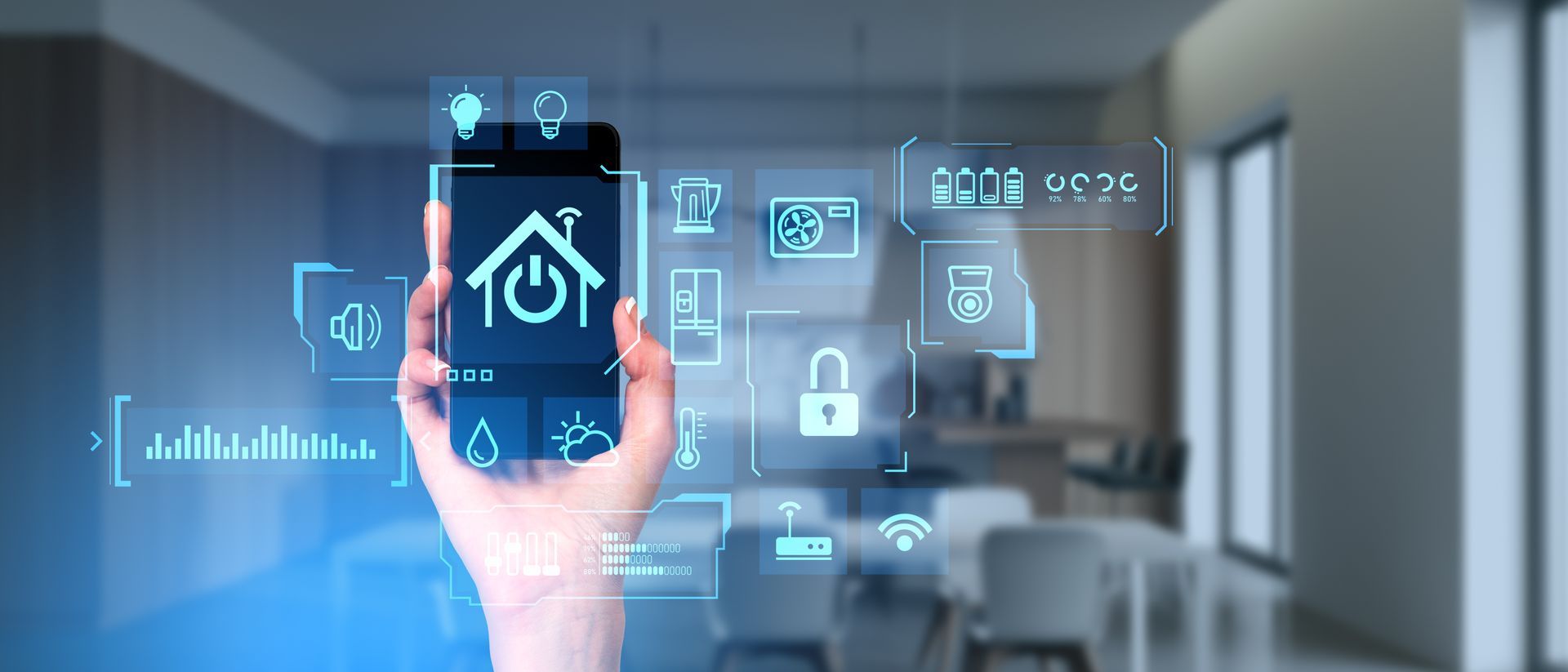 Hand of woman holding smartphone with smart home app standing in blurry kitchen.