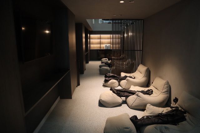 A row of bean bag chairs in a dark room