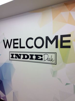 a sign on a wall that says welcome indie disk