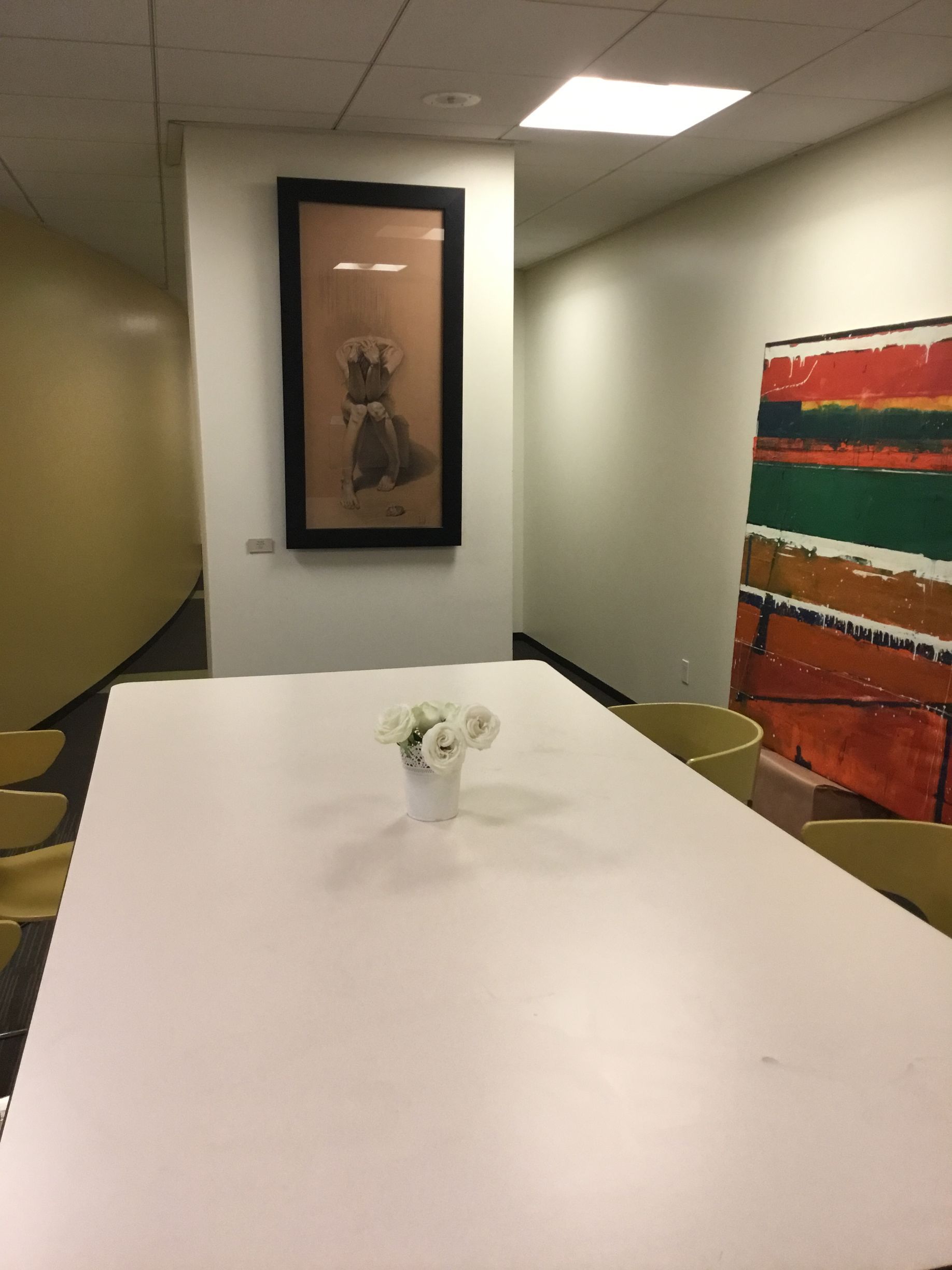 a white table with a vase of flowers on it