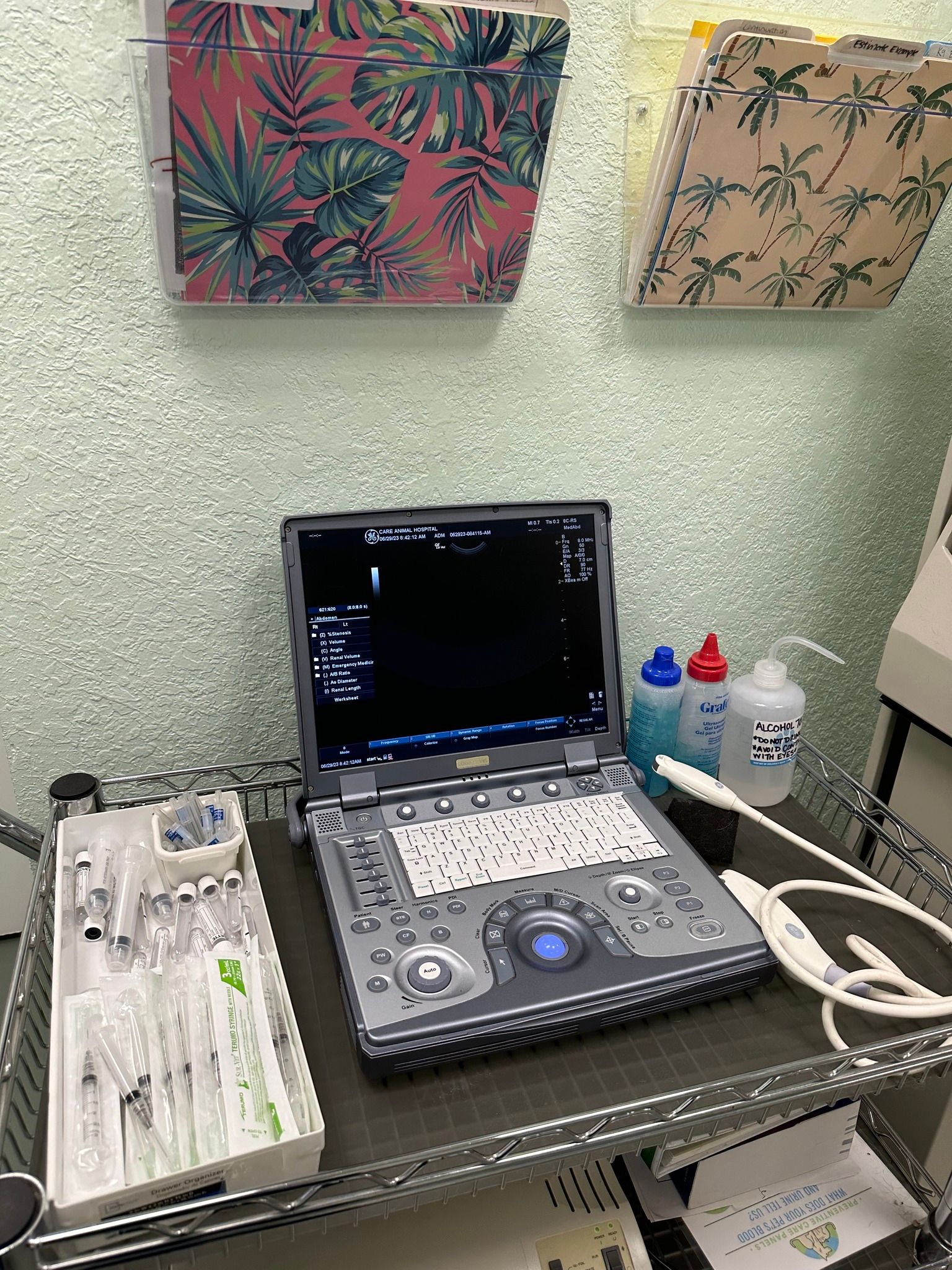 A laptop computer is sitting on top of a metal shelf.