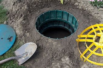 septic tank opening with shovel