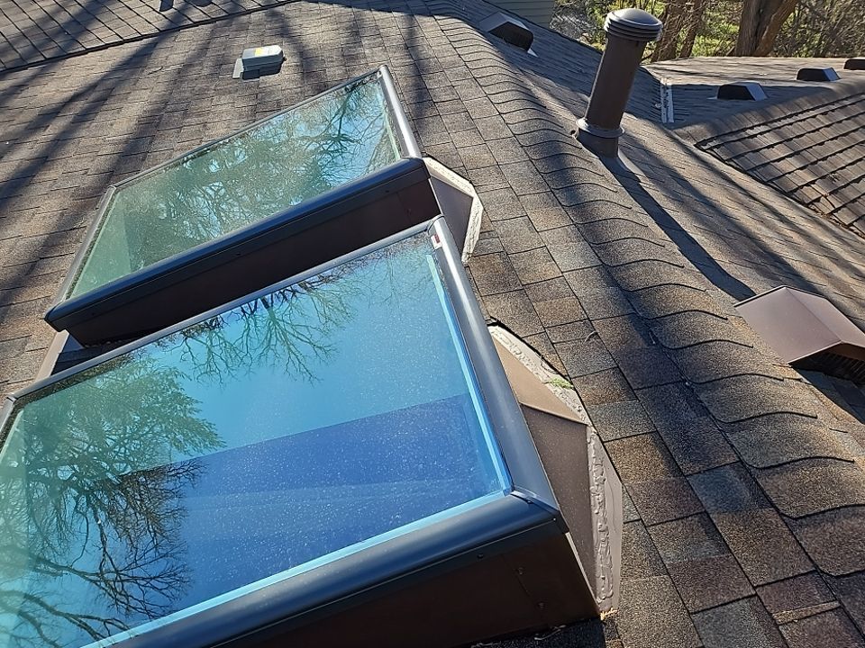 there are two skylights on the roof of a house .