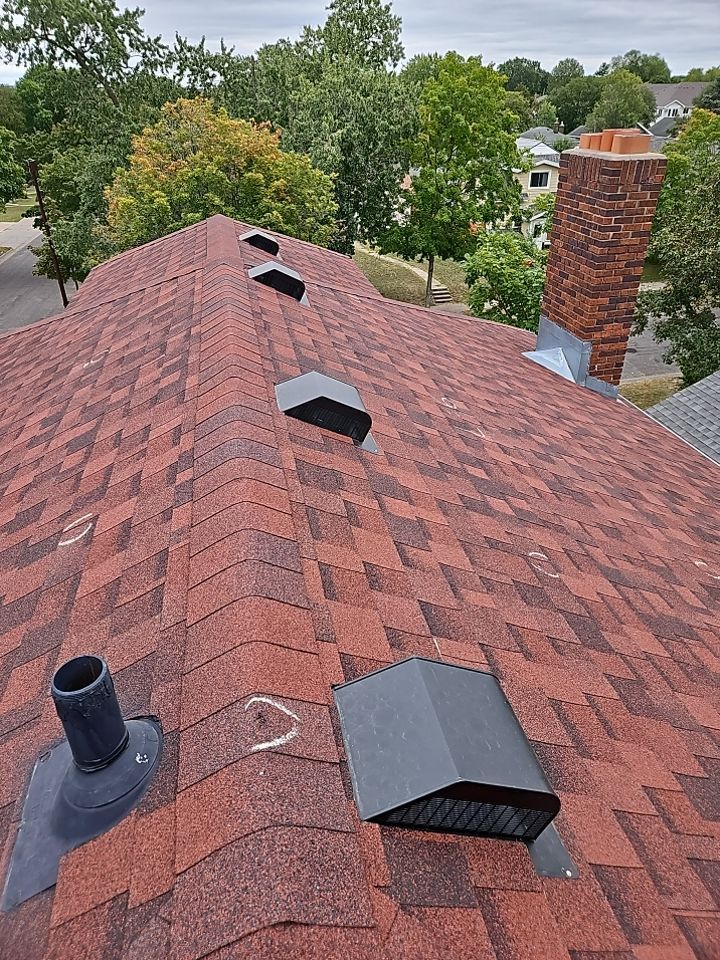 a red roof with a chimney on top of it .