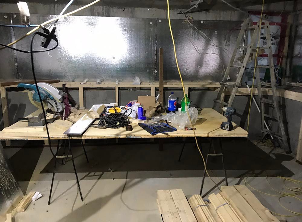 Une table en bois avec beaucoup d'outils dessus dans une pièce.