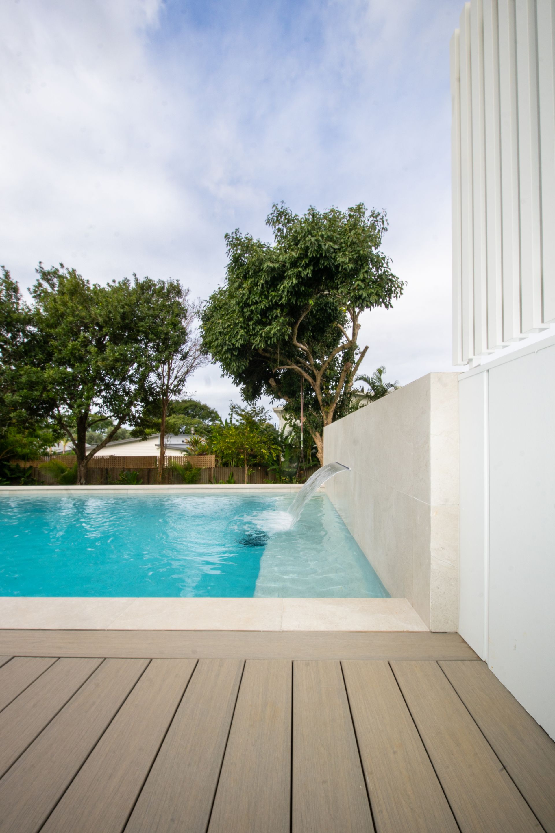 Black Pool Heat Pump Beside a Swimming Pool — Concrete Pool Projects in Gladstone Central, QLD