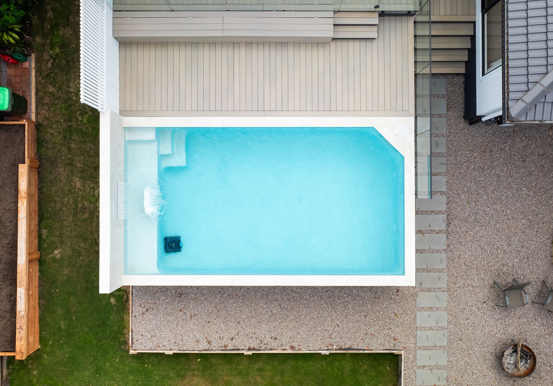 Sandy Beach With Dark Rocks and Blue Water â Concrete Pool Projects in Tannum Sands, QLD