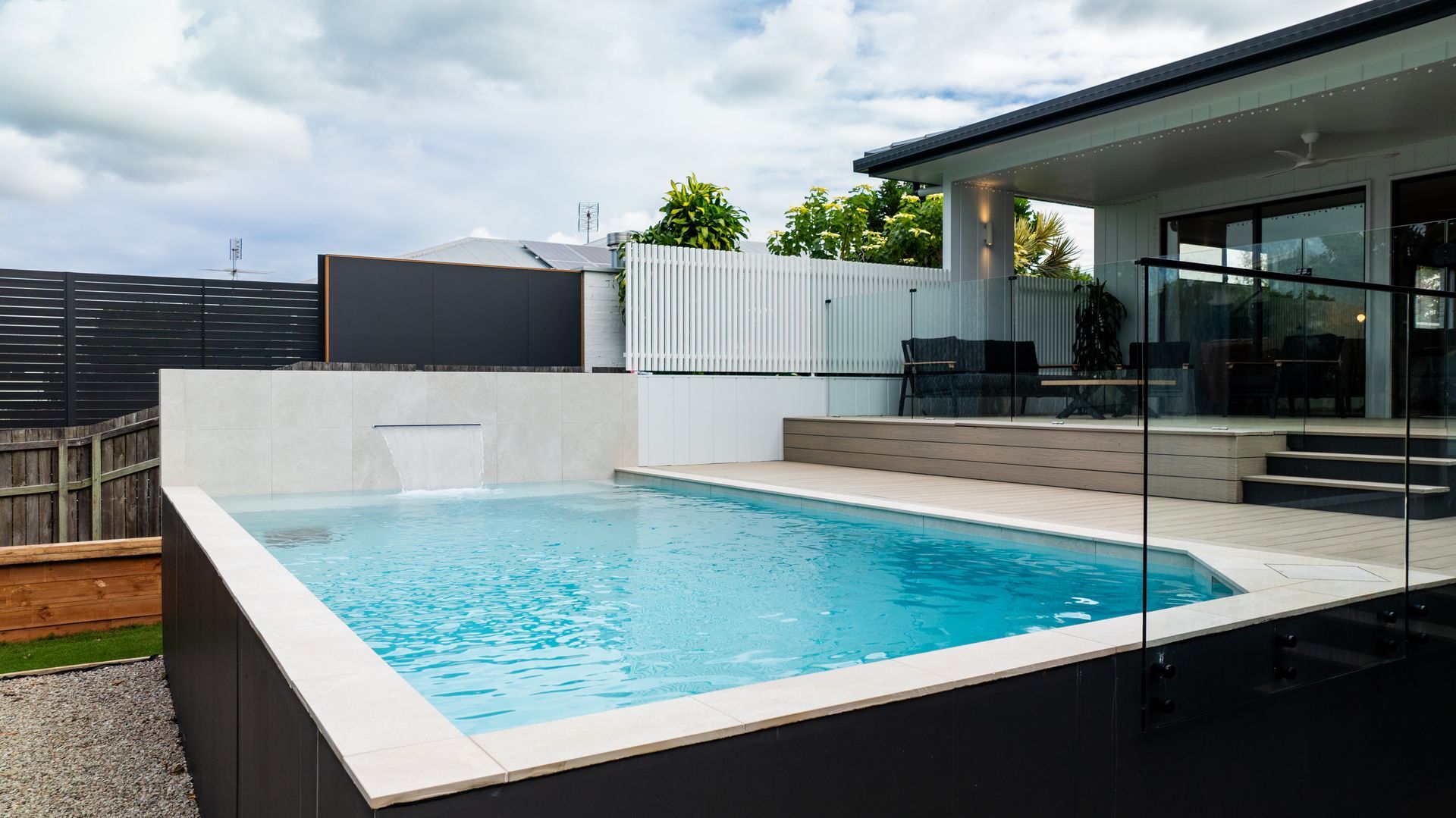 Man in Work Clothes Paints a Wall With a Roller — Concrete Pool Projects in Seventeen Seventy, QLD